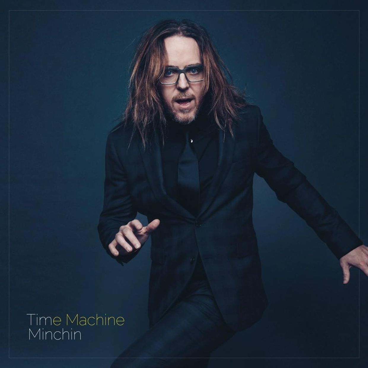 The album art for Tim Minchin's Album Time Machine. It features Tim Minchin in a dance style pose, and the words Tim Minchin, Time Machine