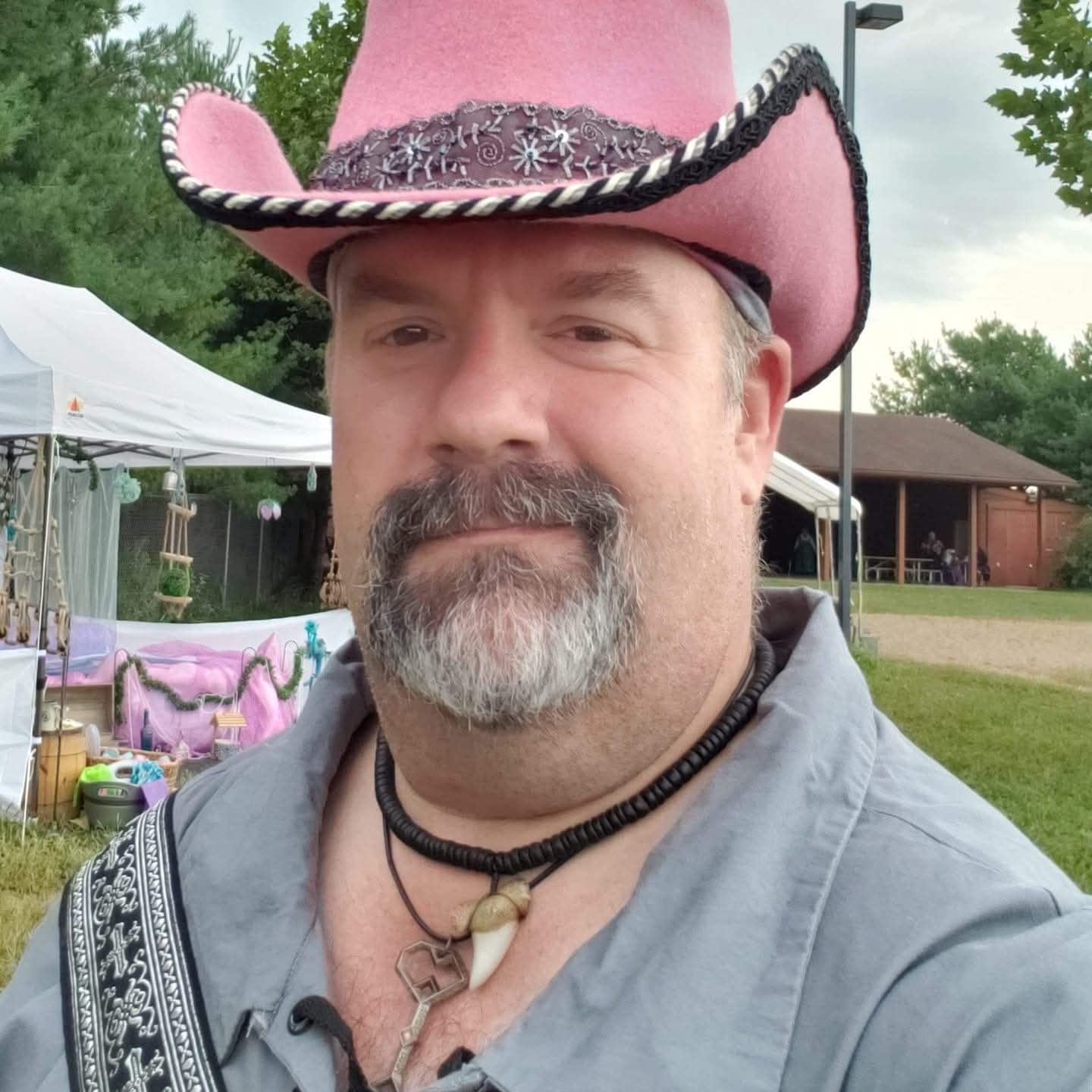Ed Miller, in a pink hat, gray shirt, outdoors